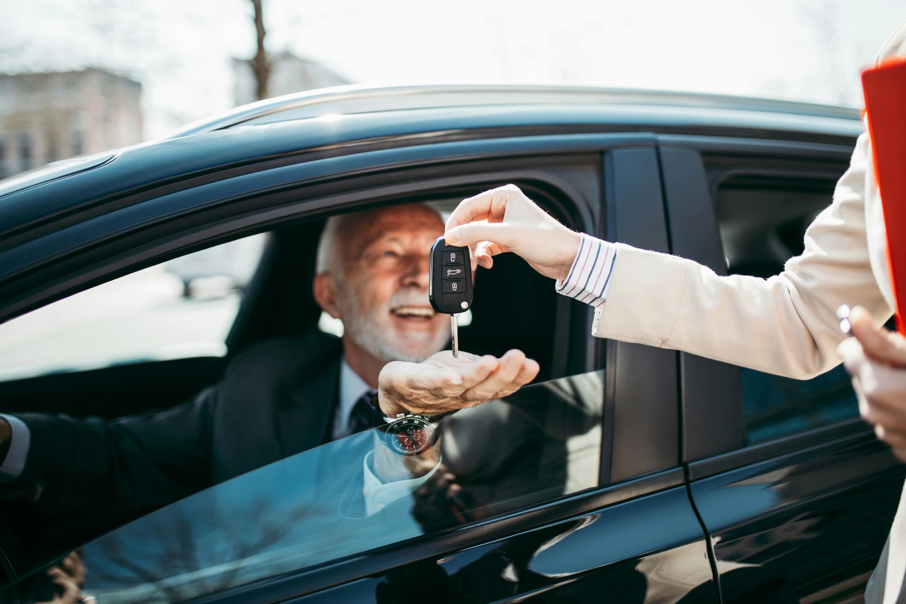 Key handover to a driver at a vehicle